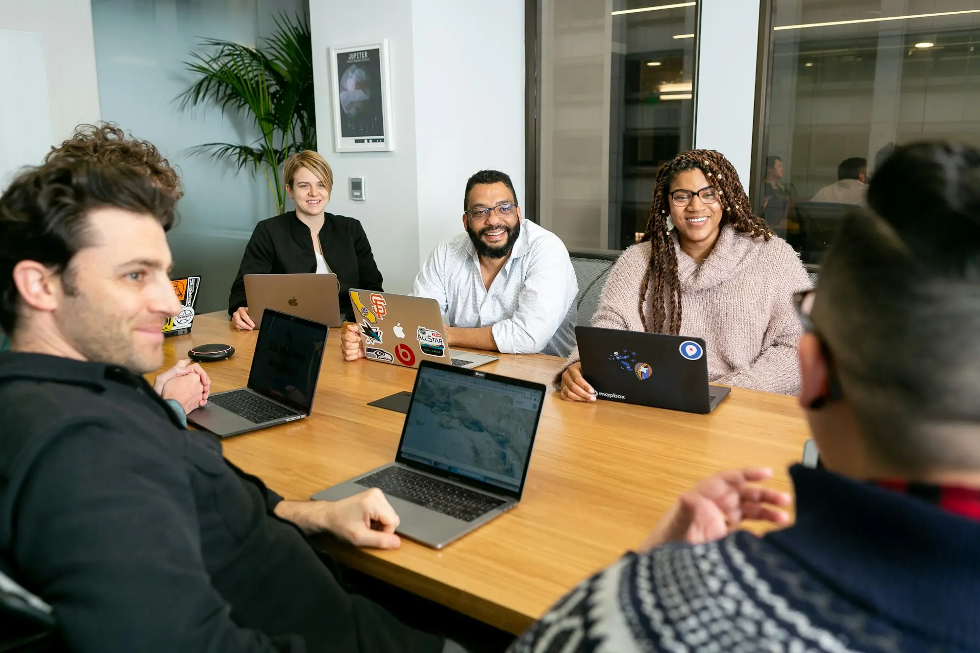 New business owner holding a relaxed team meeting with staff before opening
