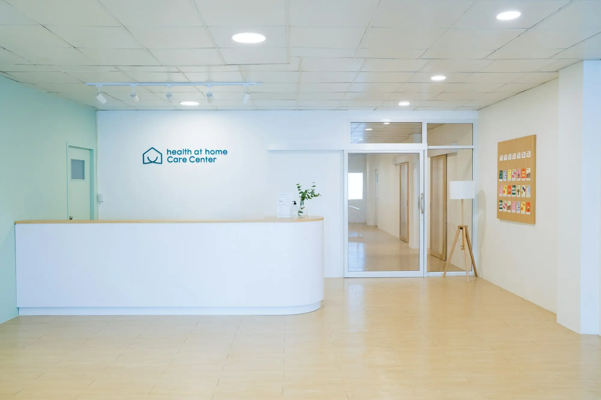 Freshly fitted-out studio reception with a curved white counter and timber floor, ready for opening day